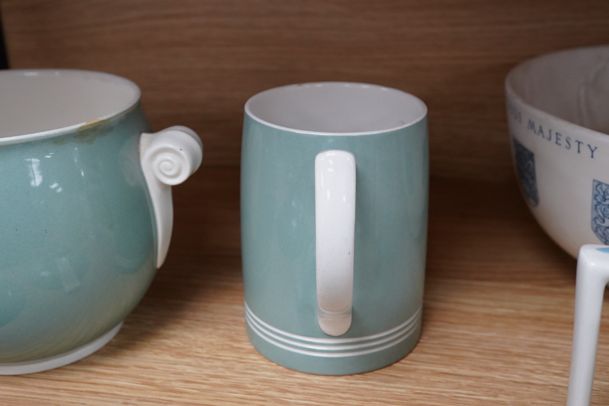 Keith Murray for Wedgwood - a celadon mug, two handled vase and two tazzas, tallest 13cm